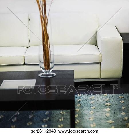 Vase on a table in front of a couch View Large Photo Image Stock Image - Vase on a table in front of a couch. Fotosearch