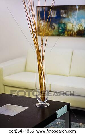 Vase on a table in front of a couch View Large Photo Image Stock Photography - Vase on a table in front of a couch. Fotosearch