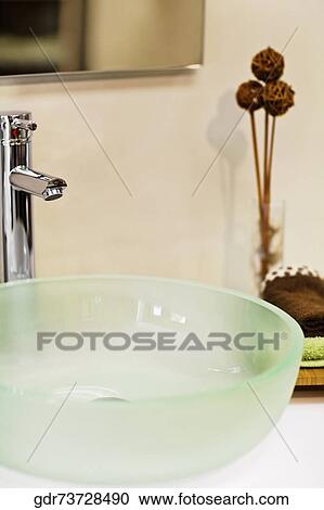 Stock Image - Vase with a wash bowl in the bathroom. Fotosearch