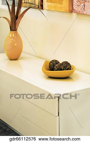 Vase with decorative balls on a sideboard View Large Photo Image Stock Photograph - Vase with decorative balls on a sideboard. Fotosearch