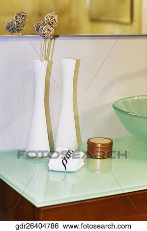 Stock Photograph - Vases near a wash bowl in the bathroom. Fotosearch