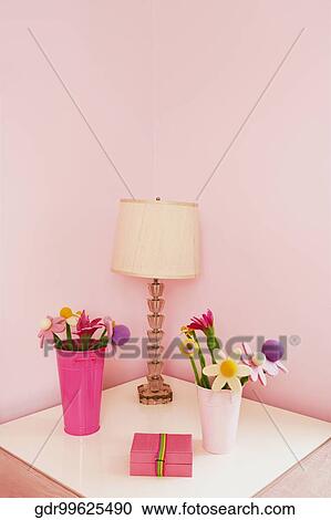 Stock Image - Vases with a lampshade on a night table. Fotosearch