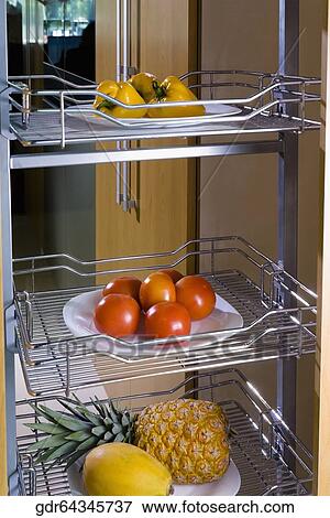 Vegetables and fruits on shelves in the kitchen View Large Photo Image Stock Photo - Vegetables and fruits on shelves in the kitchen. Fotosearch