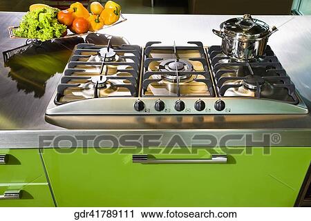 Vegetables near a stove in the kitchen View Large Photo Image Stock Image - Vegetables near a stove in the kitchen. Fotosearch