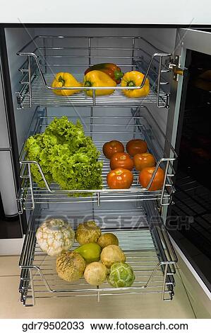 Vegetables on shelves in the kitchen View Large Photo Image Stock Image - Vegetables on shelves in the kitchen. Fotosearch