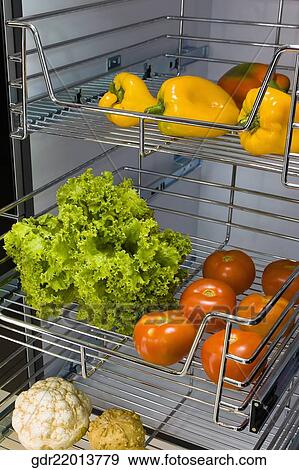 Vegetables on shelves in the kitchen View Large Photo Image Stock Photo - Vegetables on shelves in the kitchen. Fotosearch