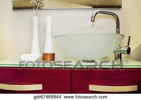 Wash bowl on a cabinet in the bathroom View Large Photo Image Picture - Wash bowl on a cabinet in the bathroom. Fotosearch