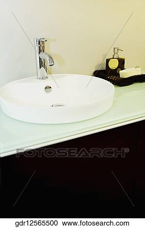 Wash bowl on a cabinet in the bathroom View Large Photo Image Stock Image - Wash bowl on a cabinet in the bathroom. Fotosearch