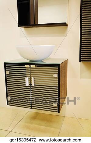 Stock Image - Wash bowl on a cabinet in the bathroom. Fotosearch