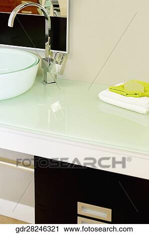 Wash bowl on a cabinet in the bathroom View Large Photo Image Stock Image - Wash bowl on a cabinet in the bathroom. Fotosearch