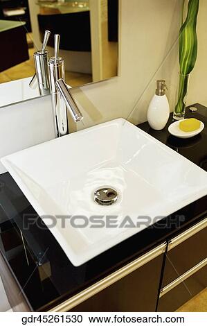 Wash bowl on a cabinet in the bathroom View Large Photo Image Stock Image - Wash bowl on a cabinet in the bathroom. Fotosearch