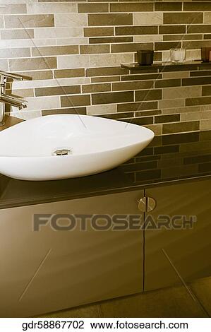 Stock Image - Wash bowl on a cabinet in the bathroom. Fotosearch