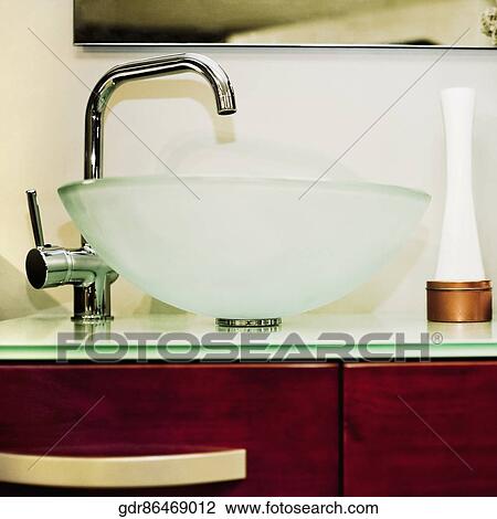 Wash bowl on a cabinet in the bathroom View Large Photo Image Stock Image - Wash bowl on a cabinet in the bathroom. Fotosearch