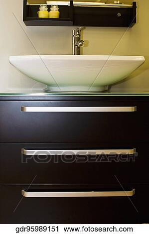 Wash bowl on a cabinet in the bathroom View Large Photo Image Stock Image - Wash bowl on a cabinet in the bathroom. Fotosearch