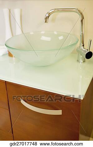 Wash bowl on a cabinet in the bathroom View Large Photo Image Stock Photo - Wash bowl on a cabinet in the bathroom. Fotosearch