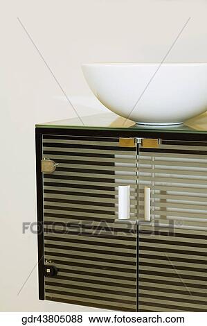 Wash bowl on a cabinet in the bathroom View Large Photo Image Stock Photo - Wash bowl on a cabinet in the bathroom. Fotosearch