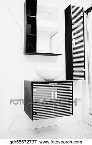Stock Photo - Wash bowl on a cabinet in the bathroom. Fotosearch