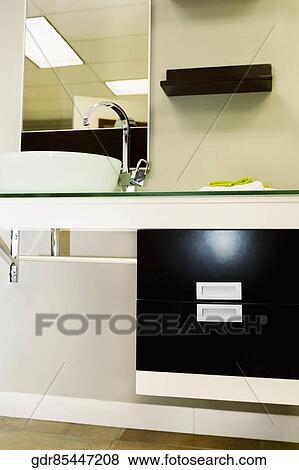 Wash bowl on a cabinet in the bathroom View Large Photo Image Stock Photo - Wash bowl on a cabinet in the bathroom. Fotosearch