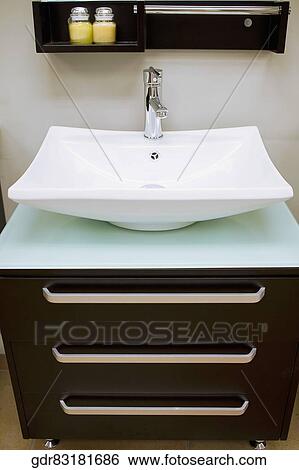 Wash bowl on a cabinet in the bathroom View Large Photo Image Stock Photograph - Wash bowl on a cabinet in the bathroom. Fotosearch