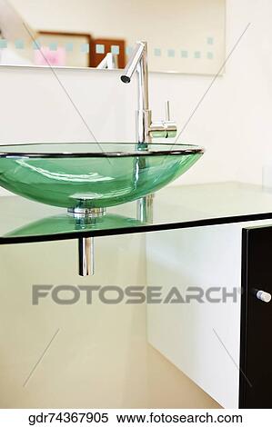 Stock Photography - Wash bowl on a cabinet in the bathroom. Fotosearch