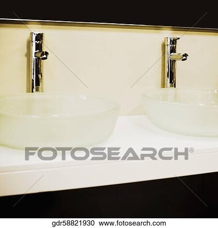 Wash bowls on a cabinet in the bathroom View Large Photo Image Stock Image - Wash bowls on a cabinet in the bathroom. Fotosearch