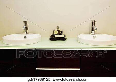 Stock Photography - Wash bowls on a cabinet in the bathroom. Fotosearch