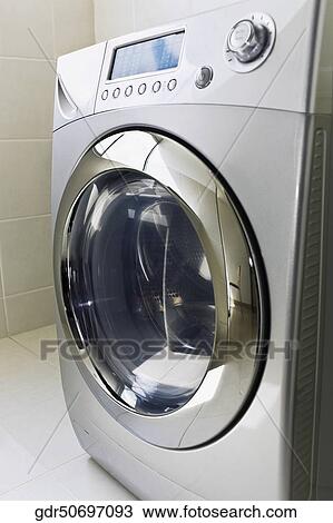 Stock Image - Washing machine in the bathroom. Fotosearch