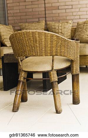 Stock Photograph - Wicker chair with a couch. Fotosearch