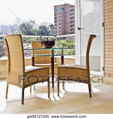 Wicker chairs with a table in the balcony View Large Photo Image Stock Photography - Wicker chairs with a table in the balcony. Fotosearch