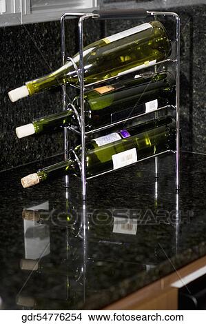 Wine bottles on a rack View Large Photo Image Picture - Wine bottles on a rack. Fotosearch