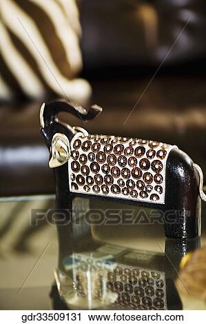 Wooden figurine of an elephant on a table View Large Photo Image Stock Image - Wooden figurine of an elephant on a table. Fotosearch