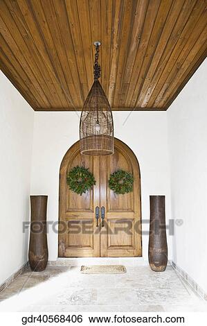 Wreaths hanging on the door of a house View Large Photo Image Stock Photograph - Wreaths hanging on the door of a house. Fotosearch
