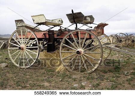 Stock Photography - Abandoned horse cart in a grassy field, Old Trail Town, Cody, Wyoming, USA. Fotosearch