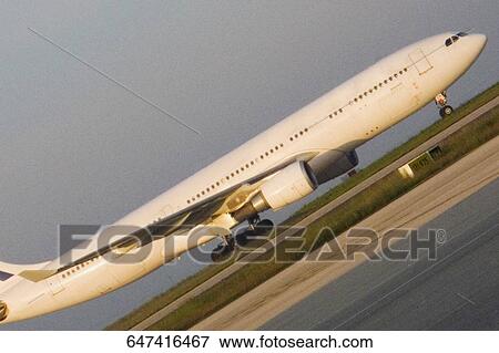Airplane on a runway, Paris, Ile-de-France, France View Large Photo Image Stock Photo - Airplane on a runway, Paris, Ile-de-France, France. Fotosearch