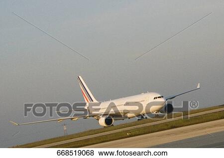 Stock Photo - Airplane on a runway, Paris, Ile-de-France, France. Fotosearch