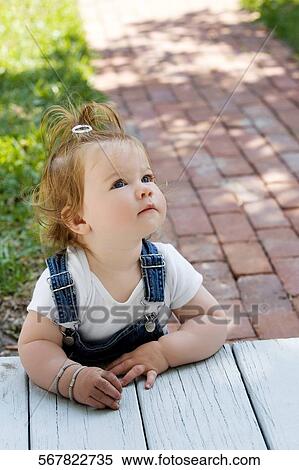Baby girl looking up View Large Photo Image Stock Photography - Baby girl looking up. Fotosearch