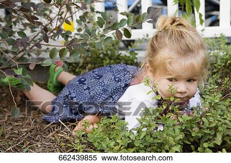 Baby girl lying in a garden View Large Photo Image Stock Photography - Baby girl lying in a garden. Fotosearch