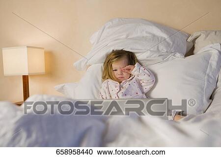Baby girl reclining on the bed View Large Photo Image Stock Image - Baby girl reclining on the bed. Fotosearch