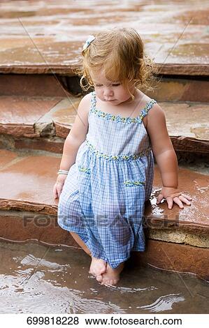Baby girl sitting at the poolside View Large Photo Image Stock Photo - Baby girl sitting at the poolside. Fotosearch