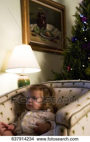 Baby girl sitting in an armchair View Large Photo Image Picture - Baby girl sitting in an armchair. Fotosearch