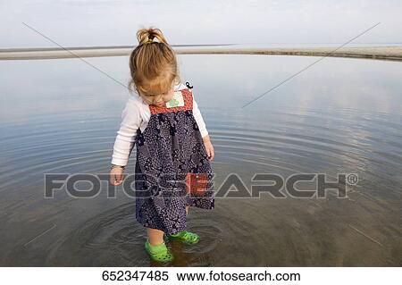 Baby girl standing in water View Large Photo Image Stock Photography - Baby girl standing in water. Fotosearch