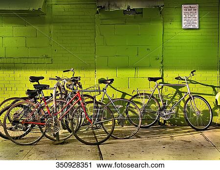 Bicycles parked in front of a building View Large Photo Image Stock Image - Bicycles parked in front of a building. Fotosearch