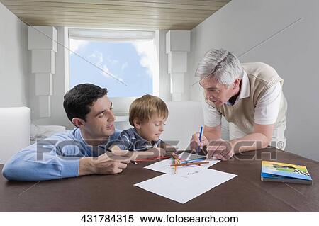 Stock Photography - Boy doing homework with the help of his father and grandfather. Fotosearch