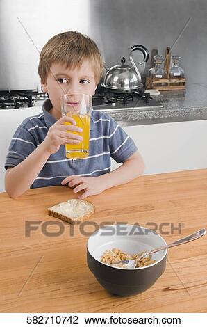 Boy drinking a glass of orange juice View Large Photo Image Stock Image - Boy drinking a glass of orange juice. Fotosearch