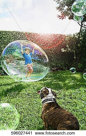Boy playing with a plastic hoop in a bubble View Large Photo Image Stock Image - Boy playing with a plastic hoop in a bubble. Fotosearch