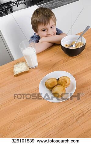 Stock Photo - Boy smiling in the kitchen. Fotosearch