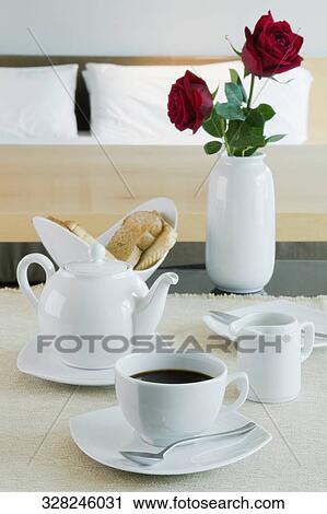 Breakfast and a vase on a table View Large Photo Image Stock Image - Breakfast and a vase on a table. Fotosearch
