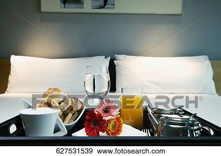 Stock Photo - Breakfast tray on the bed. Fotosearch
