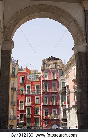 Stock Image - Building viewed through an arch, Naples, Naples Province, Campania, Italy. Fotosearch