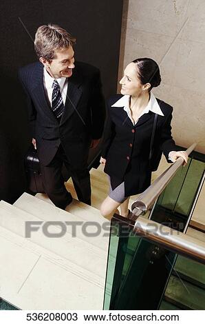 Businessman and a businesswoman moving up stairs View Large Photo Image Stock Image - Businessman and a businesswoman moving up stairs. Fotosearch